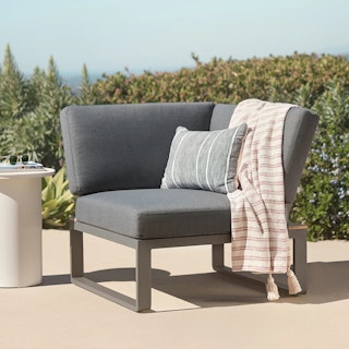 Styled patio featuring the Kezia 32" Outdoor Corner Module in Whale Gray