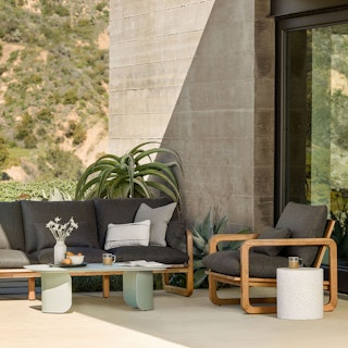 Bright sunny patio featuring the Laholm 88" Outdoor Sofa Set in Dravite Black
