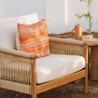 Rosa 34.5" Outdoor Lounge Chair in Dravite Ivory styled with pillows during golden hour. Photo by @nataliecarrasco_