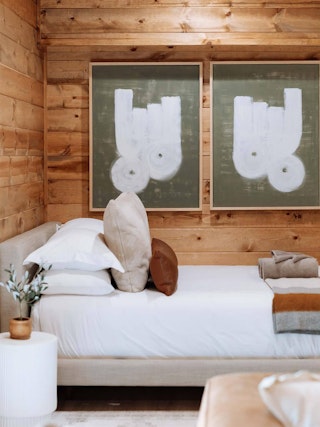 Tessu Queen Upholstered Bed featured in a cozy wood cottage, Credit The Everwoods