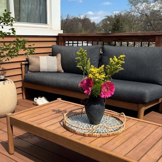Bright styled patio featuring the Rosa 110" Outdoor Sectional and Coffee Table Set in Dravite Black. Photo by @samanthaaelise