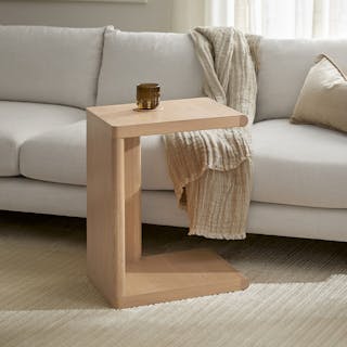 Torme C Side Table in White Oak, styled in a bright room and positioned beside a white sofa