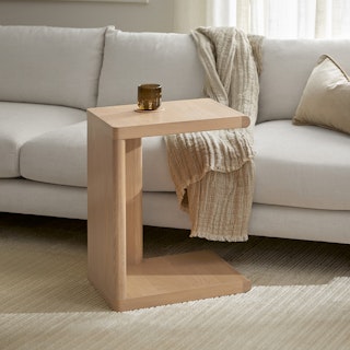Torme C Side Table in White Oak, styled in a bright room and positioned beside a white sofa