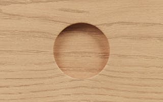 Detailed view of Adel Cabinet in White Oak finish, featuring its carved round drawer pull