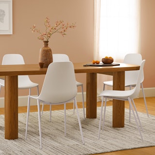 Dining space for six, highlighting the bold sculptural chunky legs on the Adel 82.5" Dining Table in Smoked Oak.
