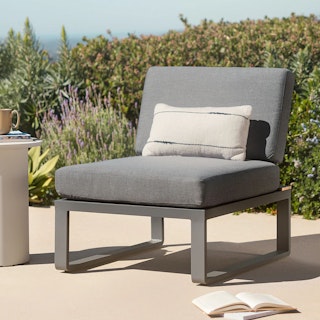 Garden patio featuring the Kezia 28" Outdoor Armless Chair Module in Whale Gray