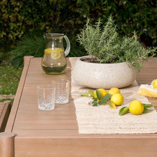 Close view of the Rosa 75" Outdoor Dining Table - Eucalyptus. Photo by @charlotteleaphotography